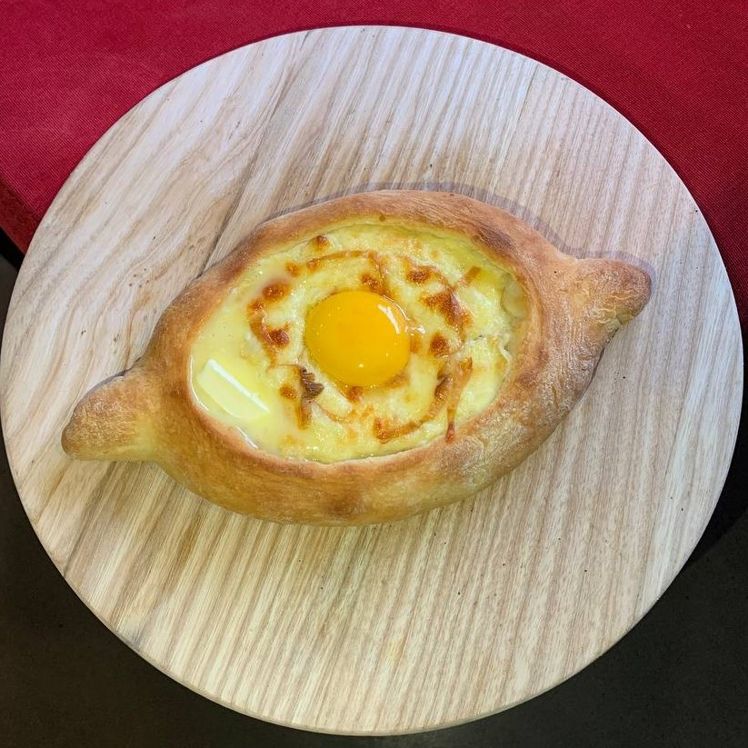 Small Khachapuri in Adjarian style with smoked suluguni